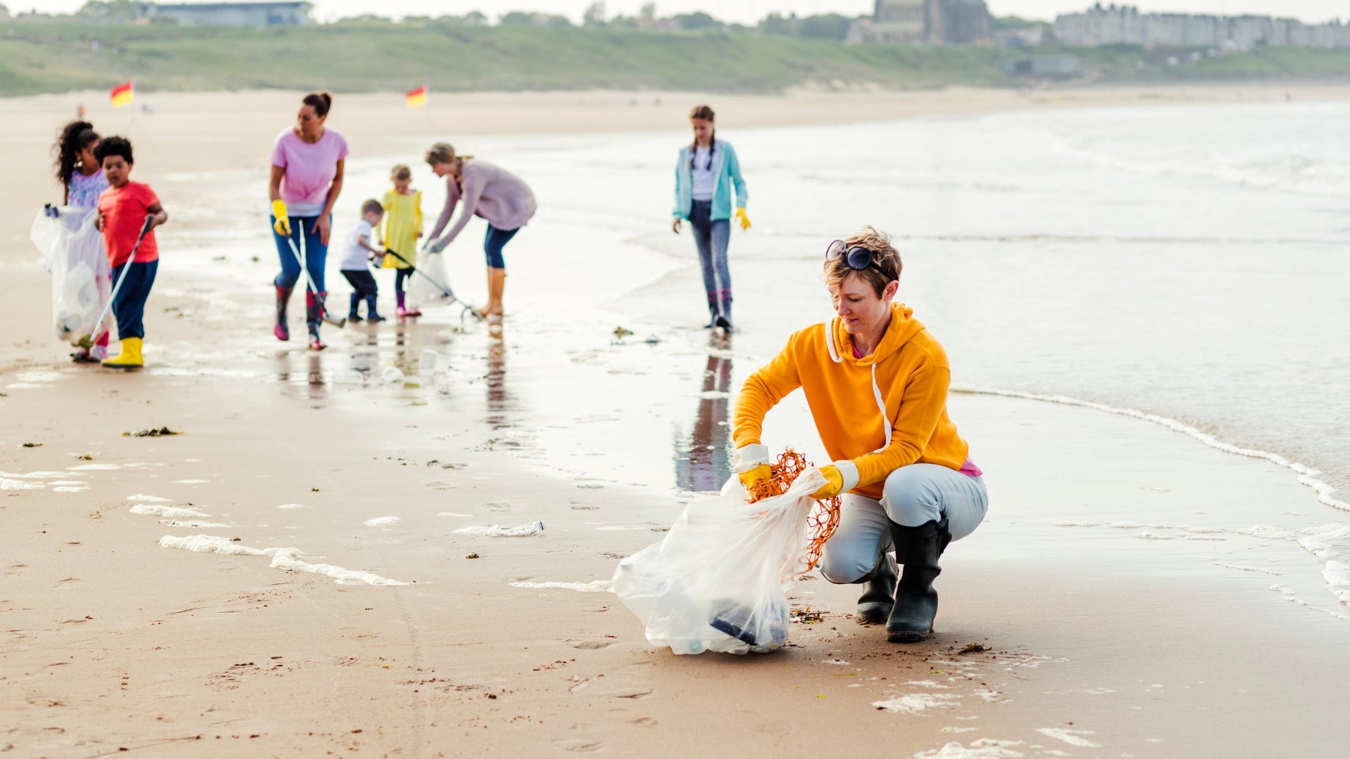 Volunteers collecting rubbish during a community beach clean-up