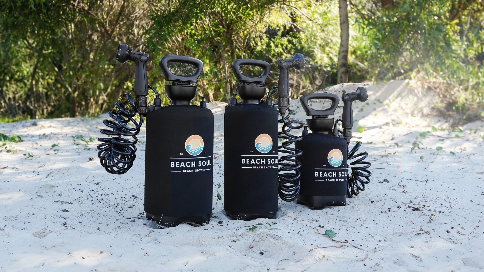 Three Beach Soul portable showers 10L Pro Food Grade, 2.1G and 1.3G set up outdoors for camping