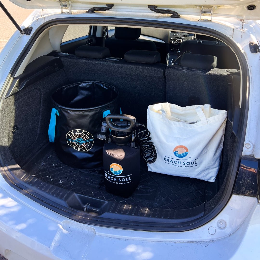 Beach Soul Beach Bag, Bag 'n' Mat and portable shower stored together in a car boot
