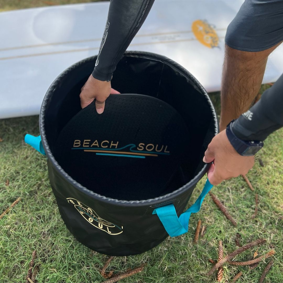 Person folding the rinse mat back into the Beach Soul Bag 'n' Mat